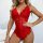 A woman poses wearing a red lace bodysuit with a deep v-neckline, showcasing intricate floral patterns and sheer fabric detai...