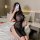 A woman poses on a bed wearing a black mesh sheer high-slit lingerie set, holding a phone to take a selfie. the outfit featur...