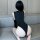 A woman sits on a couch wearing a black bodysuit with lace detailing, showcasing an elegant and seductive design. the one-pie...