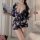 A woman models a stylish, floral-patterned japanese kimono sleepwear set, featuring a deep v-neckline and flowing fabric, per...