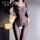 Woman wearing domiela sheer bodystocking with chain details and open-crotch design.