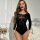 A stylish black long-sleeved lingerie set featuring intricate mesh patterns and elegant design details, perfect for adding al...