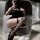 Gorgeous cloud black fishnet over-the-knee stockings - sexy lace mesh long thigh highs for women, showcased on a stylish woma...