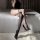 Gorgeous cloud sexy over-the-knee fishnet stockings - black lace-up rivet long tube socks for bold style, showcased on a bed ...