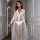 Sexy lace mesh sheer long nightgown for women, featuring a delicate design with long sleeves and a flowing skirt, perfect for...