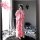 A person wearing a pink floral japanese-style kimono, capturing themselves in a mirror surrounded by colorful balls and decor...