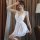 Elegant white lace sleep dress with sheer fabric, featuring a split-back design for a sensual look. perfect for evening wear.