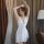 Elegant white lace sleep dress with sheer fabric and split-back design, perfect for sensual evening wear.