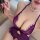 Woman wearing purple long night lingerie set with lace mesh details and pearl necklace, showcasing sensual sleepwear design.