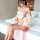 A woman models a sheer pink chinese-inspired lingerie set featuring a delicate belly band and flowing chiffon elements, perfe...