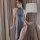 A woman poses elegantly in a sheer ice silk nightgown, featuring a high neck and thigh-high slit, perfect for a sexy yet soph...