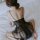A woman sits on a bed wearing a sheer black long night seductive lingerie set, featuring delicate lace and thin straps, perfe...