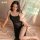 Elegant black sheer mesh sleep dress with side slit and adjustable straps, perfect for women seeking comfort and style.