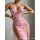 A woman wearing a pink floral lace sheer split long nightgown, featuring ruffled straps and a plunging neckline.