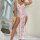 A woman poses elegantly in a plus-size sexy lace sheer split long nightgown, featuring floral patterns and a high slit design...