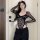 Woman modeling pure & seductive lace bodysuit - style long sleeve sexy matching set for women with black pants.