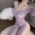 Woman wearing purple lace cheongsam dress with off-shoulder design, high slit, sheer fabric, and butt cutout. holds white fea...
