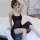 A woman poses elegantly wearing a black sheer lace sleep dress, featuring a delicate mesh design and long transparent nightwe...