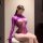 Woman wearing purple sheer mesh long sleeve bodysuit with lace detailing, tight fit, plus size & small bust friendly design.