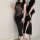 Woman in black sheer bodycon dress with lace mesh, high slit, and tight fit—perfect for nightlife or parties.