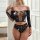 Woman wearing black rhinestone two-piece lingerie with off-shoulder long sleeves and cutout details, perfect for nightlife.