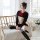 A woman models a black sailor collar long sleeve role play costume with red accents, paired with striped knee-high socks, sit...