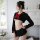 A woman models a black sailor-style costume with red accents, featuring long sleeves and a pleated skirt, perfect for photosh...