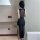 Elegant black bodycon dress with sheer back detail and thigh-high slit, perfect for nightclub wear and special occasions.
