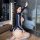 A woman poses in a stylish black swimsuit with white accents, featuring long sleeves and an open design, perfect for role pla...