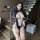 A woman poses confidently wearing a stylish blue and white one-piece swimsuit bodysuit with long sleeves, designed for role p...