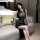 A woman poses elegantly in a sheer black lace bodycon dress, featuring a sheer mesh design and long flowing skirt, perfect fo...