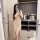 A woman poses with her face obscured by a phone, wearing a sheer lace sleep dress. the elegant design features a long hem and...