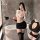 Woman in yeyu seductive long-sleeve bodycon mini skirt lingerie set, posing with feather duster in modern bathroom.