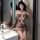 Woman wearing loveruru sexy leopard print bodysuit bikini, tight-fit nightclub lingerie set with cutouts and long gloves.