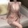Woman wearing lustrous deep v-neck sequin bodysuit with cross-back design, sparkling lingerie for women, factory direct.