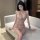 Woman wearing lustrous deep v-neck lace bodysuit with sparkling sequins and cross-back design, elegant erotic lingerie.