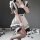 A woman wearing a cute maid costume cosplay dress, featuring black and white colors with ruffles and stockings, perfect for j...
