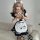 A woman wearing a maid costume cosplay dress, featuring a black and white striped design with a cute apron adorned with paw p...