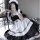 A woman poses wearing a maid costume cosplay dress, featuring black and white colors with ruffles and a sailor-style collar. ...