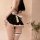 A woman models a maid costume lingerie set featuring a black dress with white ruffles and a bow, paired with thigh-high stock...