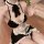 A woman wearing a maid costume lingerie set, featuring black and white ruffled details, perfect for cosplay or sleepwear.