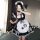 A girl wearing a maid lolita dress, featuring a black and white checkered apron with cat paw prints, along with a matching he...