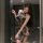 A woman poses in a sheer lace dress featuring a floral pattern, designed as a qing dynasty silk cheongsam lingerie set. the d...
