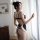 Woman wearing manny night sexy maid costume, red & white lace bodysuit with backless cutout and pure temptation lingerie set.