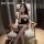 Woman wearing mannyan bunny girl bodysuit costume, a sexy sheer mesh open-crotch outfit with bunny ears, posing in a chair fo...