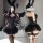Woman modeling mannyan dark angel corset set—black lace mesh bodysuit with boning, strapless top, tutu skirt & wings.