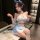 A woman poses wearing a mannyan japanese maid costume set, featuring a ruffled off-shoulder corset and high-slit skirt, paire...