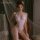 Woman wearing mannyan white lace deep v-neck bodysuit with bow details and open-crotch design, sheer mesh sleepwear.