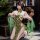 Woman modeling mannyan seductive lace cheongsam lingerie, a sheer silk-feel side-tie qipao outfit with green floral patterns.