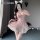 Woman modeling pink mannyan lace babydoll dress with sheer mesh, ruffled skirt, and maid-inspired design.